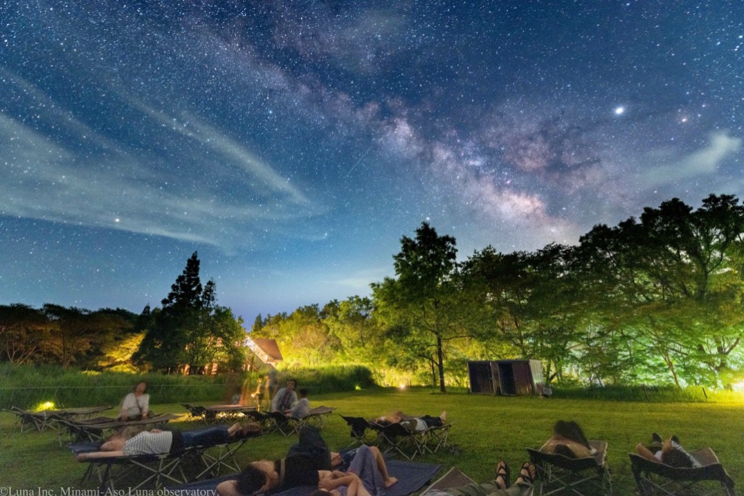 Guests reclining outdoors beneath the sky at Minami-Aso Luna Observatory